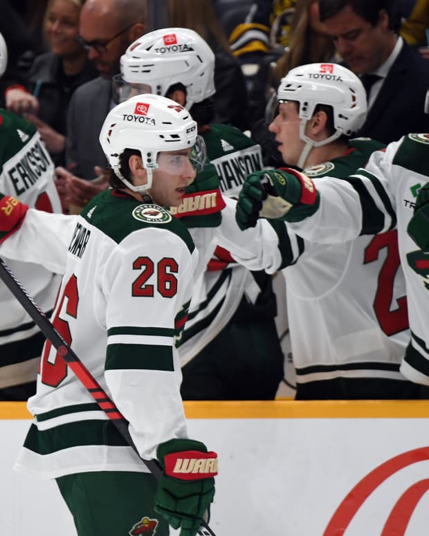 Caption: Feb 29, 2024; Nashville, Tennessee, USA; Minnesota Wild center Connor Dewar (26) celebrates with teammates after a goal during the first period against the Nashville Predators at Bridgestone Arena.